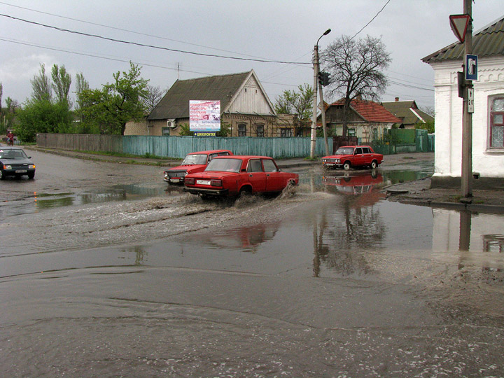 Трое красных жигулей в луже в начале ул. Александра Невского около моста на Карла Либкнехта в Мелитополе